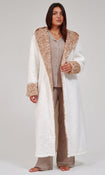 A woman wearing a plush white bathrobe with a leopard patterned hood and cuffs, posed against a neutral light gray background.