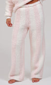 A person wearing plush, wide-leg fleece pajama pants in a pale pink and white striped pattern, shown from the waist down against a light gray studio background.