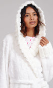 A woman wearing a plush white hooded robe with a shawl collar, photographed against a plain light gray studio background.
